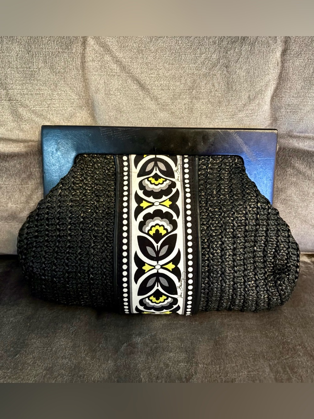 Vera Bradley black straw clutch Fanfare pattern featuring a wood frame handle